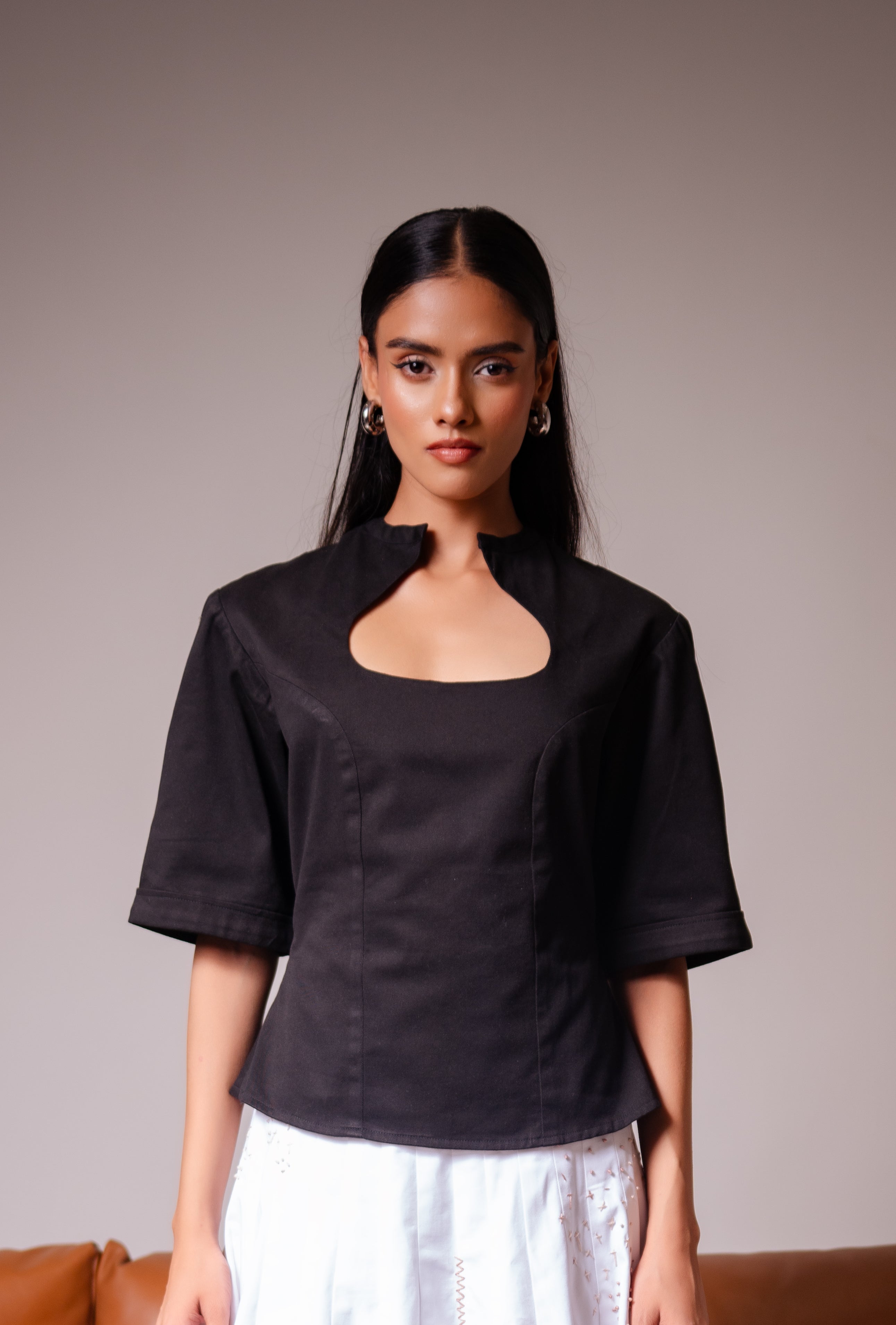 All Hearts No Spades luxury women’s black top with half sleeves and an interesting neckline with minimalist tailoring – quiet luxury premium clothing.