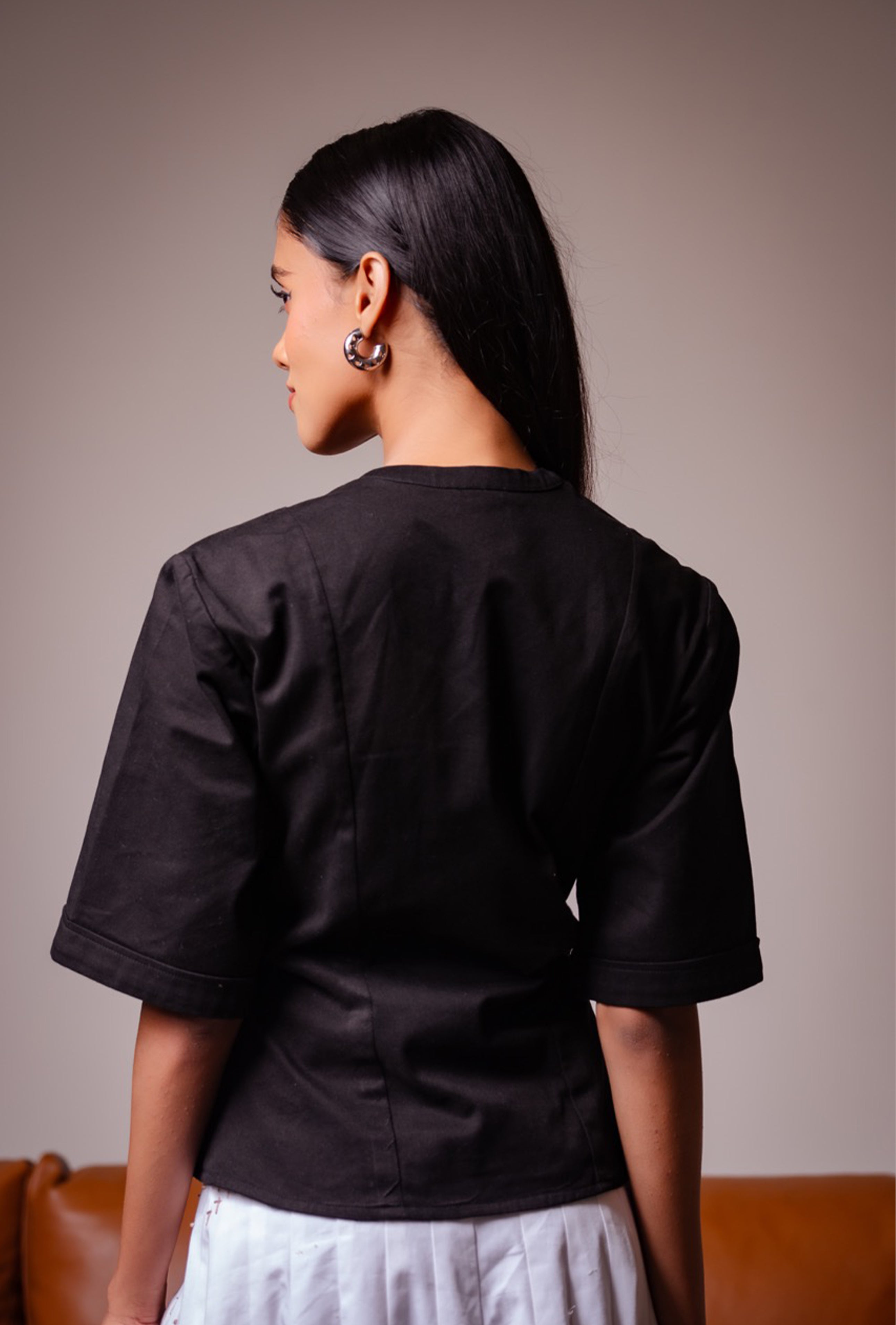All Hearts No Spades luxury women’s black top with half sleeves and an interesting neckline with minimalist tailoring – quiet luxury premium clothing.