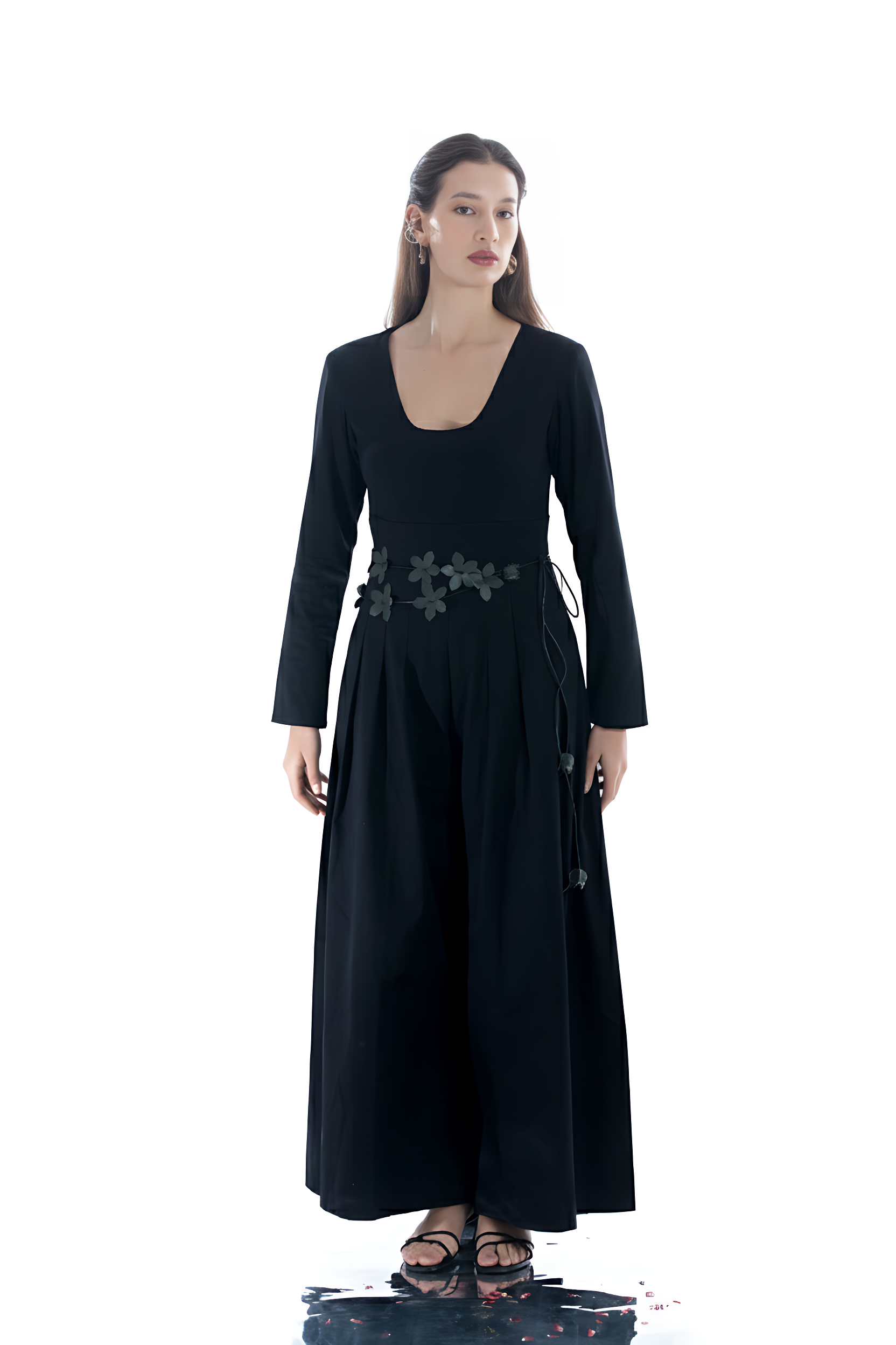 Woman wearing a black dress with floral embellishments on a white background