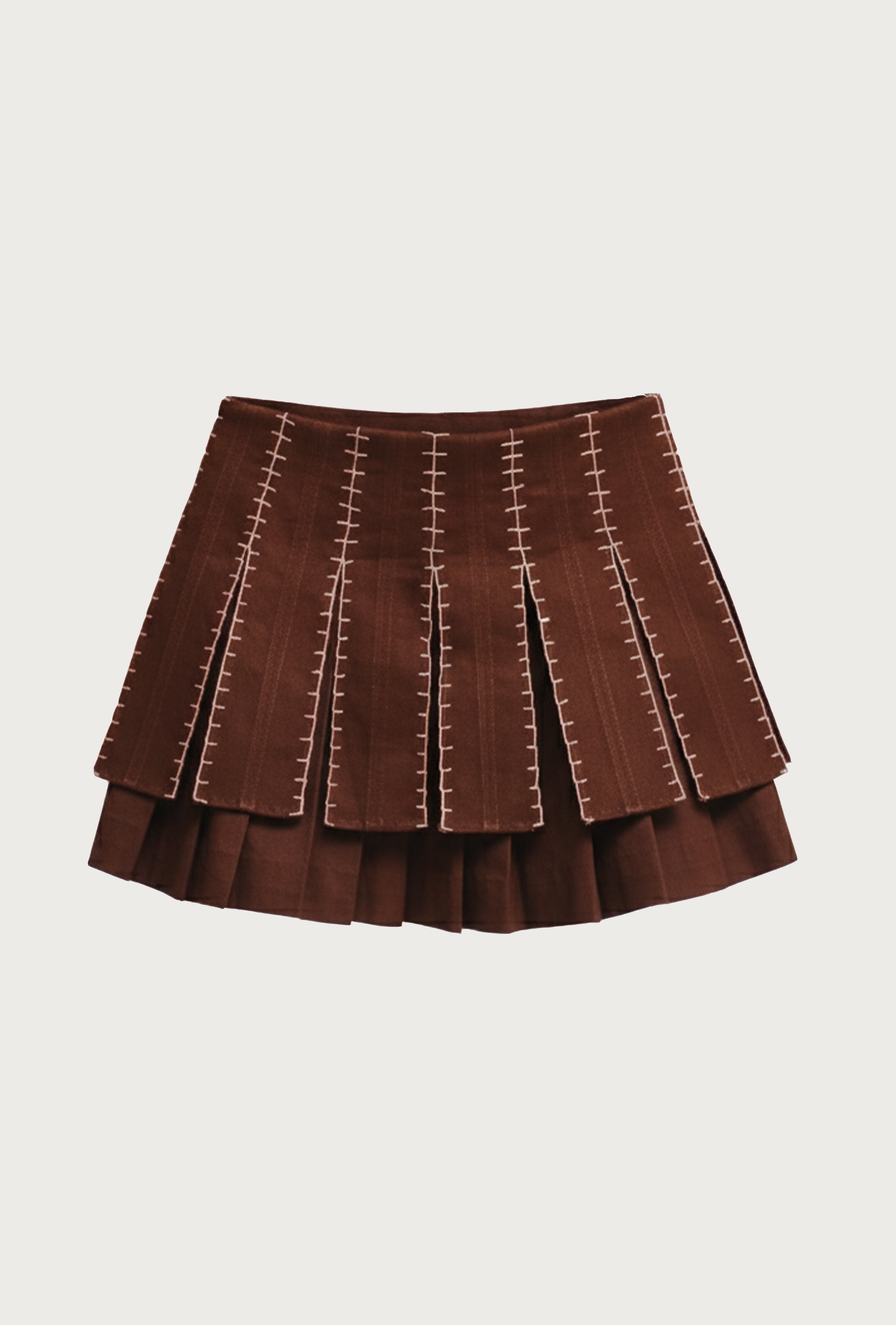 Brown pleated skirt with decorative stitching on a light beige background